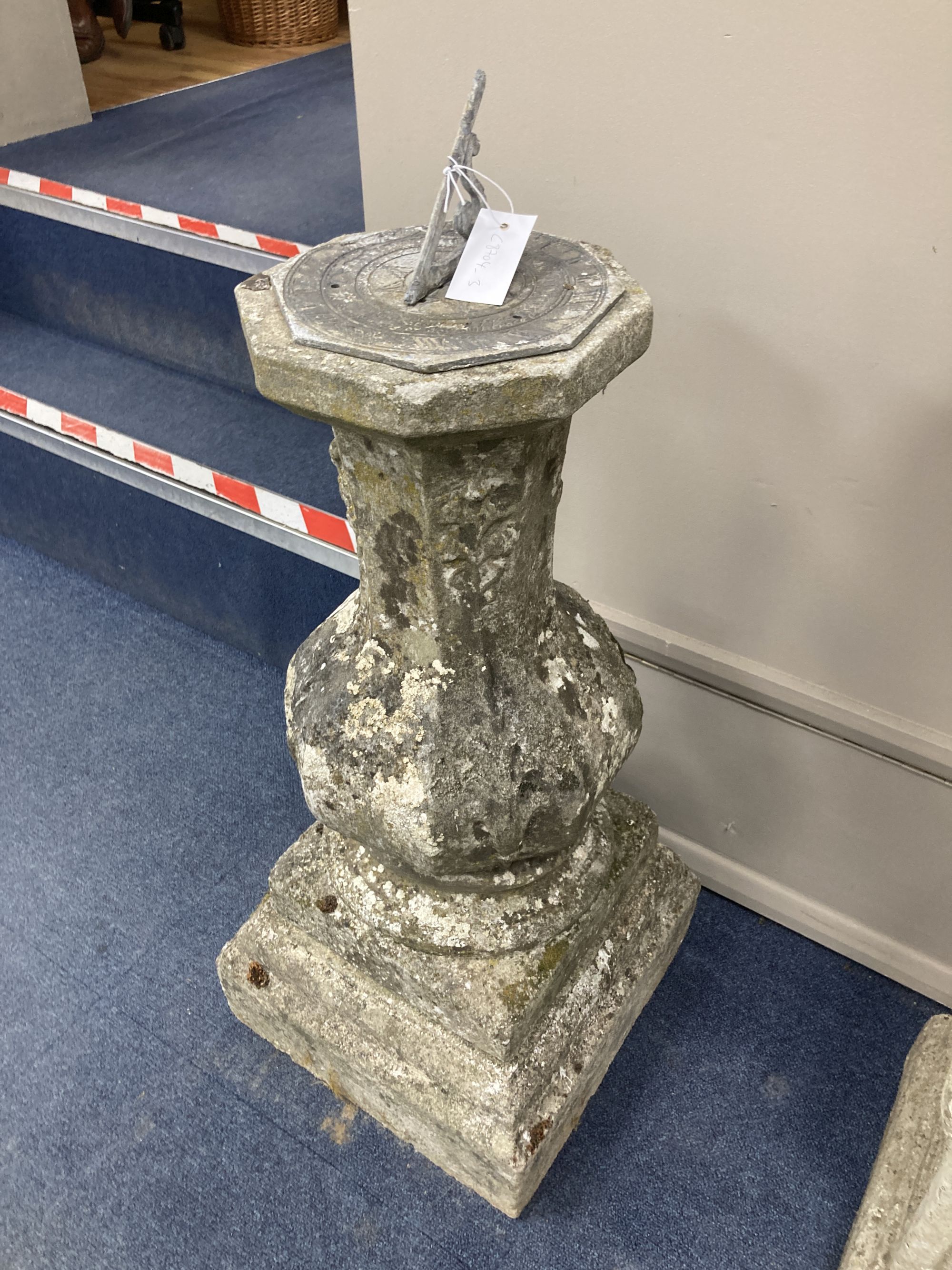 A weathered reconstituted stone sundial, height 90cm